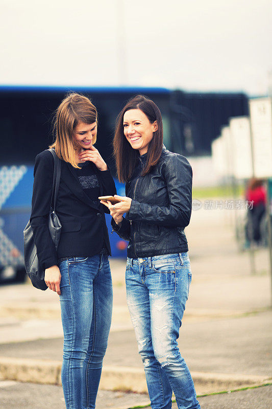 Young women waiting on the bus station